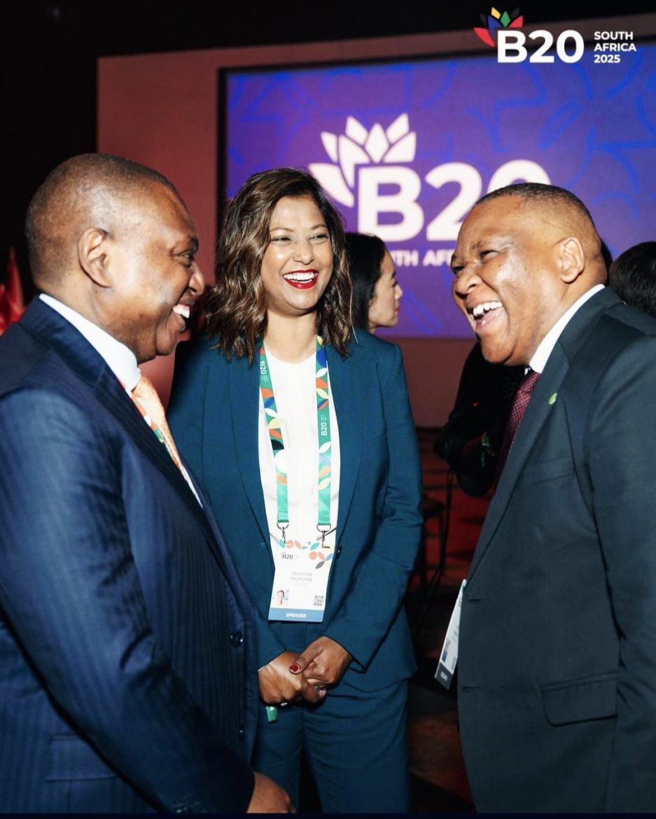 A female and 2 males, chatting excitedly at the 2025 B20 event on the sidelines of the G-20 South Africa. They are all dressed in suits.